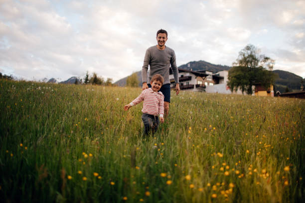Photo of father and his son who enjoy being outdoors in the nature