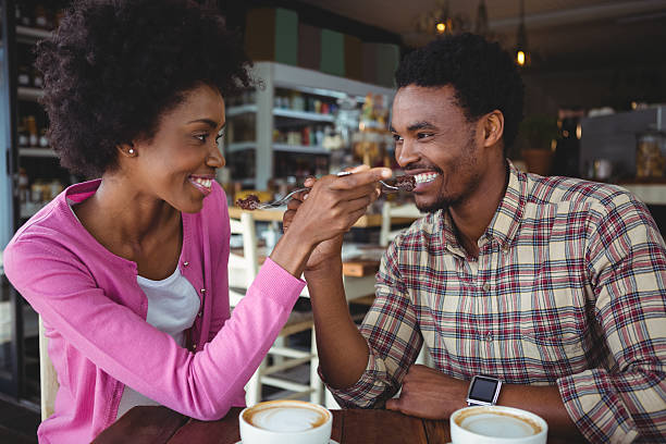 istock Young couple feeding each other 600373176