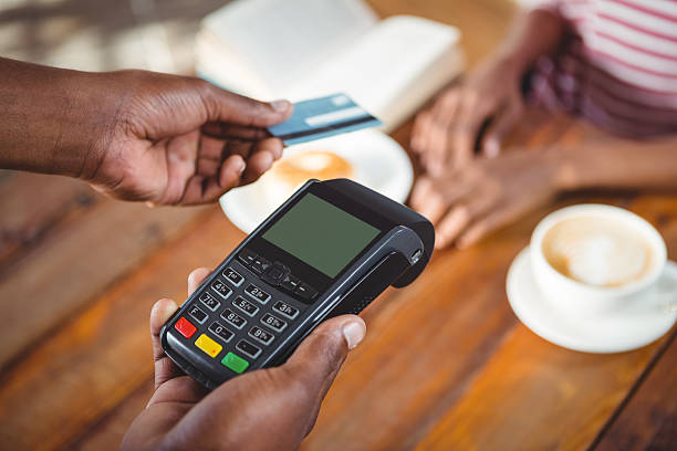 istock Waiter holding credit card machine 600373456