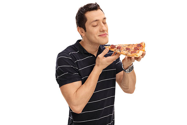 istock Young man smelling a slice of pizza 600374098