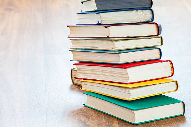 istock the lying multi-colored books on a wooden table. 600375674