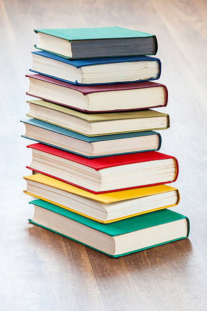 istock the lying multi-colored books on a wooden table. 600375762