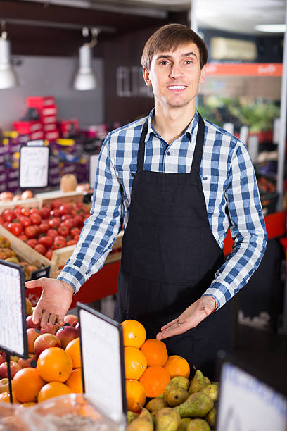 istock young man offering fruits 600378716