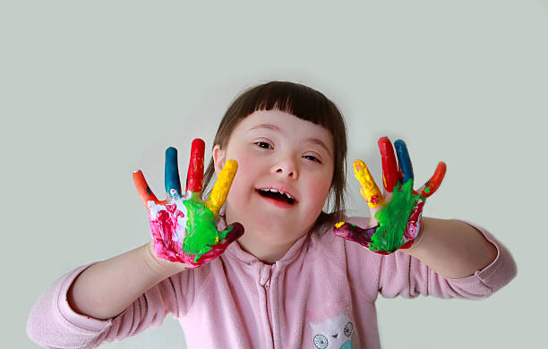 istock Cute little girl with painted hands. Isolated on grey background. 600381228