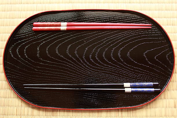 istock Chopsticks lying on Japanese traditional Urushi laquerware plate 600382010
