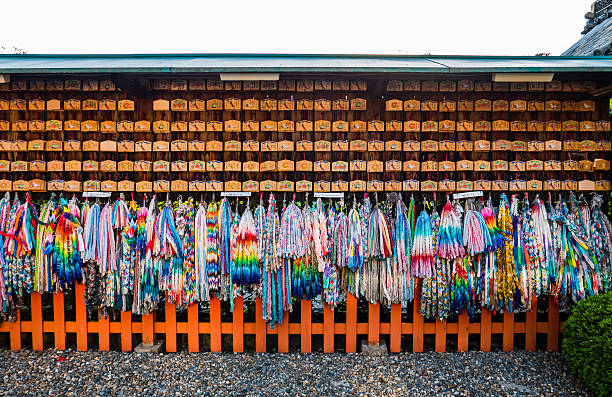 Kyoto, Japan - May 4, 2016: Origami cranes and prayer tablets at Fushimi Inari Shrine. Fushimi Inari Taisha is the head shrine of Inari, located in Fushimi-ku, Kyoto, Japan.