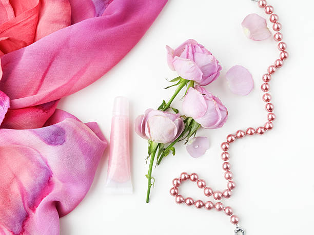 istock pink roses and pearl necklace on white background. Top view. 600386152