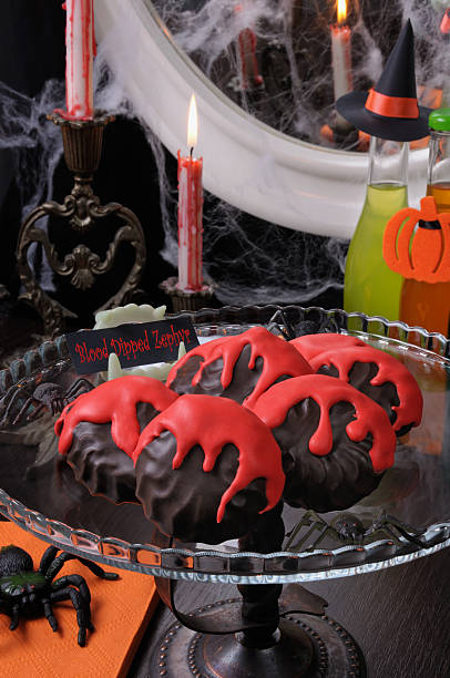 Blood dipped zephyr Zephyr in chocolate glaze with a bloody streaks   the table on Halloween sunken cake stock pictures, royalty-free photos & images