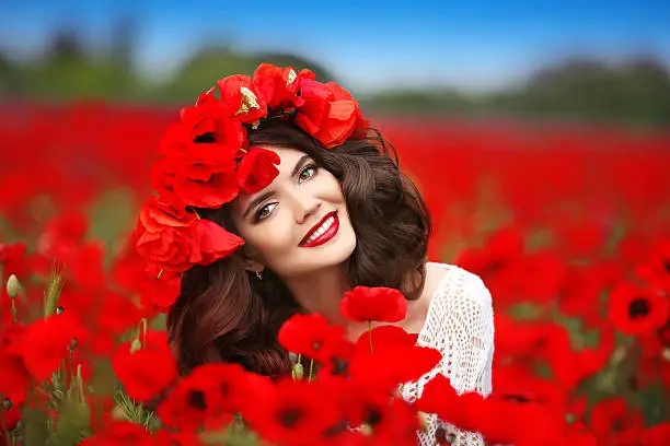 Photo of Beautiful happy smiling teen girl portrait with red flowers