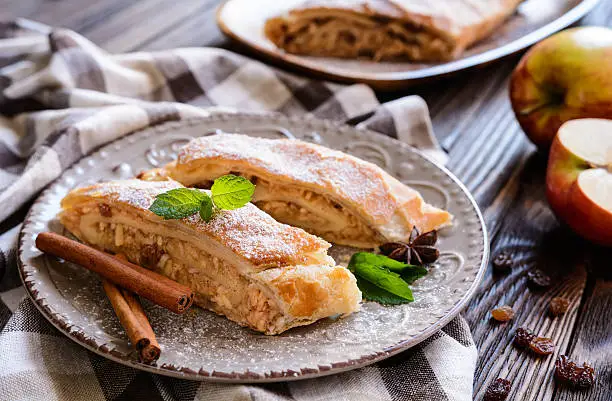 Traditional puff pastry strudel with apple and raisins filling