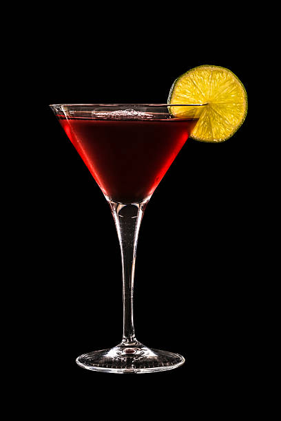 Cosmopolitan cocktail Cosmopolitan or cosmo, is a cocktail made with vodka, triple sec, cranberry juice, and freshly squeezed or sweetened lime juice served in a martini glass isolated on black background. vodka photos stock pictures, royalty-free photos & images
