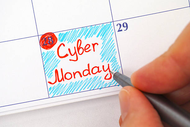 istock Person hand with pen writing Cyber Monday in calendar 600390214