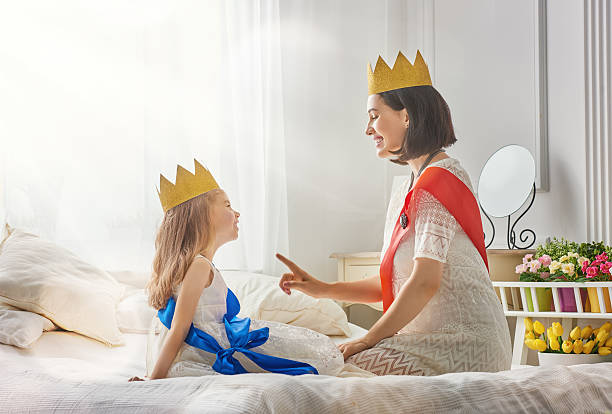 istock queen and princess in gold crowns 600390340