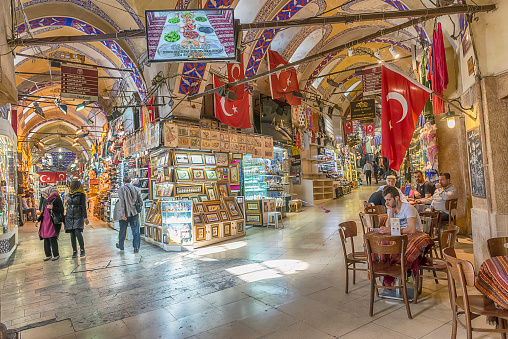 Istanbul, Turkey - May 19, 2016: Unidentified people in Grand Bazaar, Istanbul. The Grand Bazaar in Istanbul is one of the largest and oldest covered markets in the world, with 61 covered streets and over 4,000 shops which attract between 250,000 and 400,000 visitors daily.