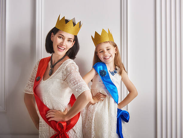 istock queen and princess in gold crowns 600390610