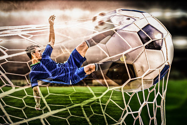 istock soccer striker shooting ball in the stadium 600394722