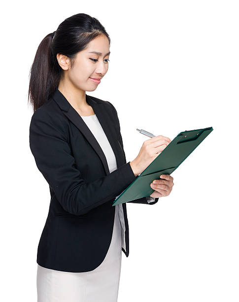 istock Chinese businesswoman writing on a clipboard 600395302