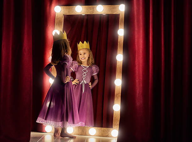 Cute little actress. Cute little actress. Child girl in Princess costume on the background of theatrical scenes and mirrors. stage actress stock pictures, royalty-free photos & images