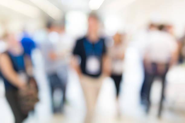 istock Abstract blurred people socializing during coffee break at business conference. 600396048