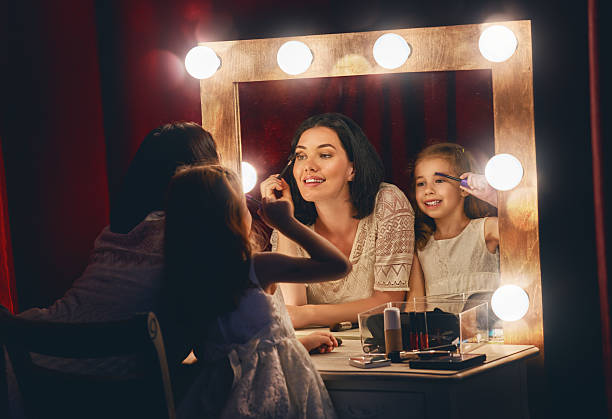 istock Mother and daughter are doing makeup 600396218