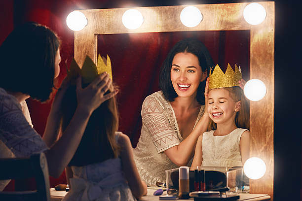 istock Mother and daughter are doing makeup 600396278