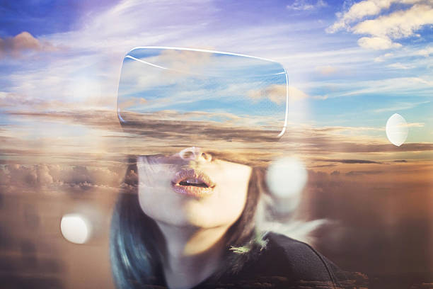 istock Young woman looks fascinated into Virtual Reality Headset 600396834