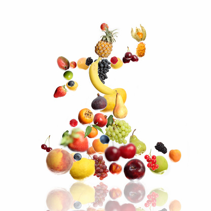 Huge file with a lot of fruits in shape of a dancing woman. Photo compilation, selective focus for 3D effect. 