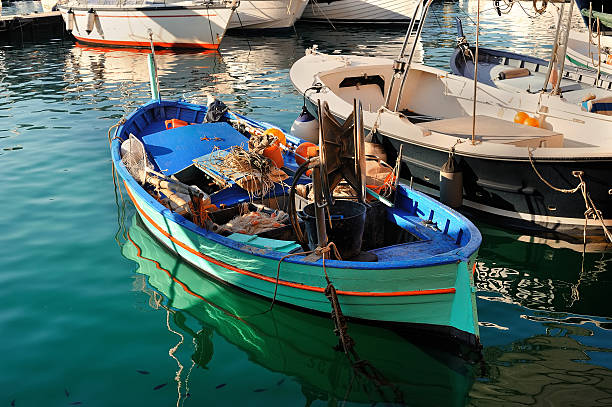 istock Fishing boat with some  gear inside moored in the port 600399426