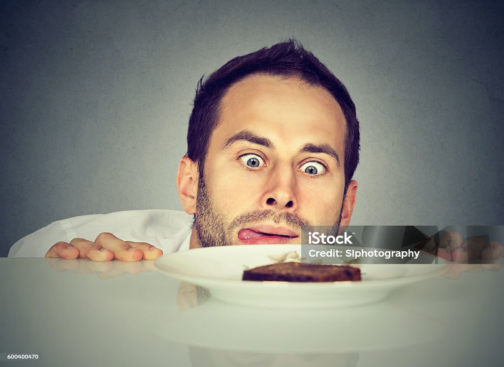 Hungry man craving sweet food Addiction Stock Photo