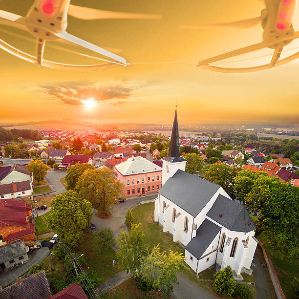 Beautiful sunset over gothic church St. Peter and Paul in The Litice suburb of Pilsen. Aerial view from drone to romantic citiscape in Czech Republic, Central Europe. HDR (warm filtered) photography.