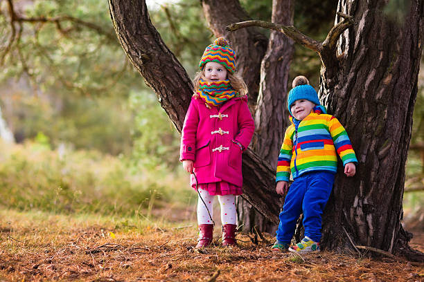 istock Happy kids playing in autumn park 600402528