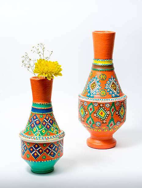 istock Two colorful pottery vases with yellow flower on white background 600403016