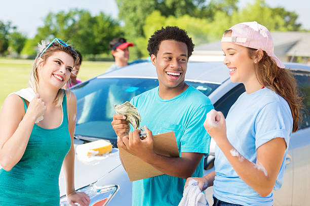 istock Playful diverse friends have fun during a car wash 600403268