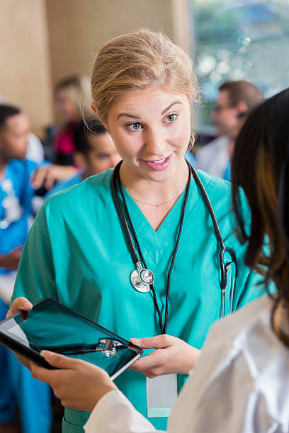 istock Confident young nurse talks with doctor about a patient 600403388