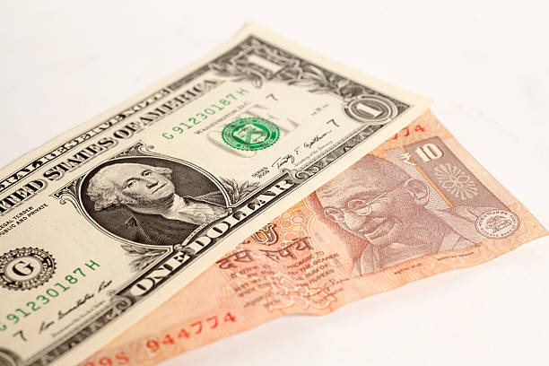 istock American one dollars and Indian ten rupee banknote 600403548