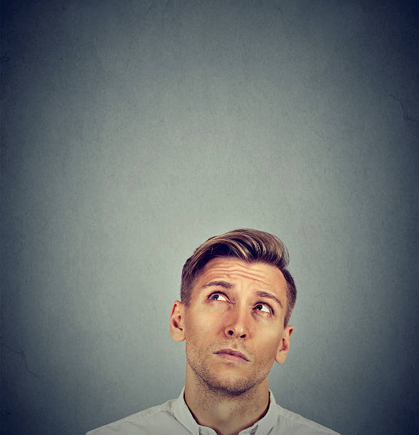 istock Headshot confused man thinking looking up 600403586