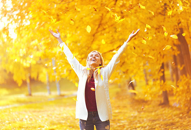 istock Leaf fall, happy expression woman having fun in sunny autumn 600403734