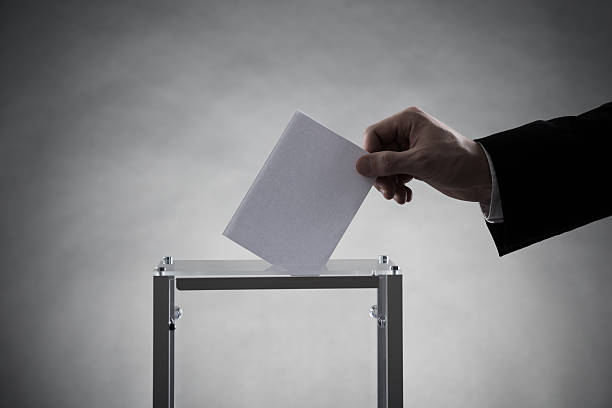 istock Hand Putting Ballot In Glass Box 600405024