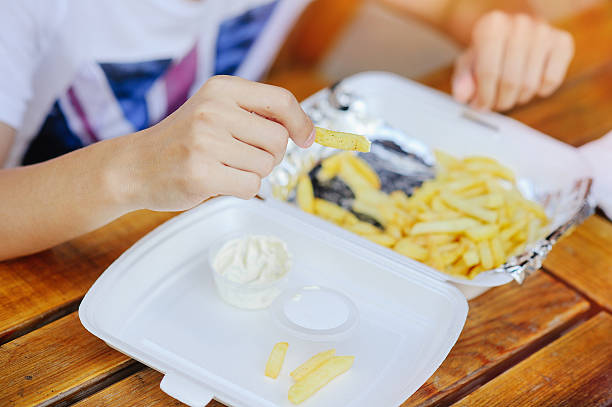 istock man eats French fries 600405572