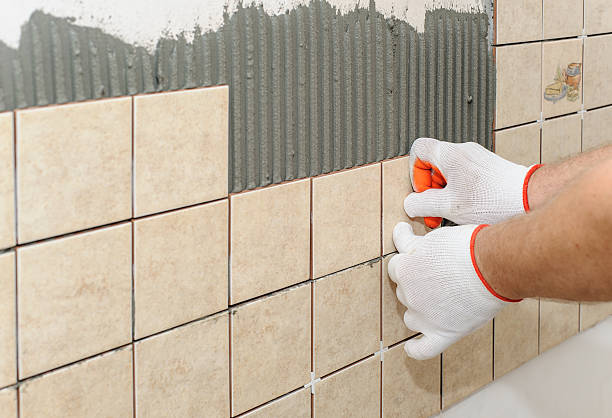 istock Worker  putting  tiles on the wall in the kitchen. 600406154