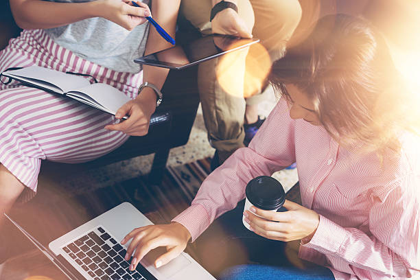 istock Group Young Business People Gathered Together Discussing Creative Idea Cafe 600406864