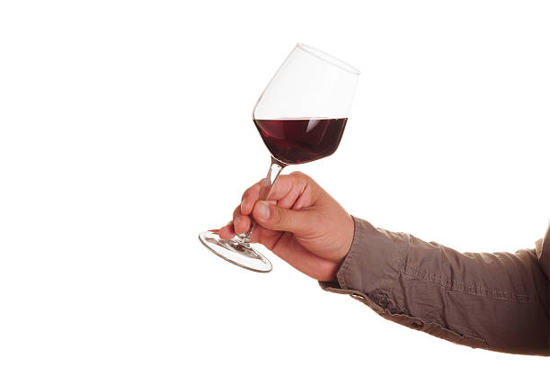 istock Male hand with red wine glass 600407522