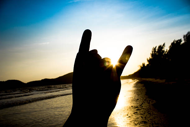 istock rock on sign in silhouette scene 600408800