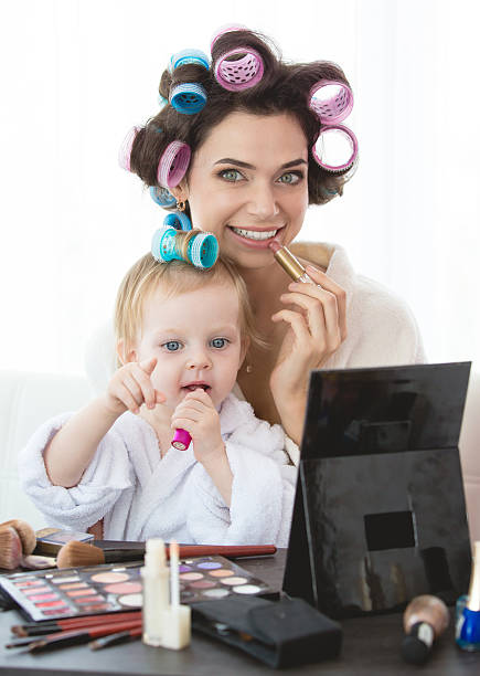 istock Mother and daughter are doing hair, manicures, makeup, having fun. 600409090
