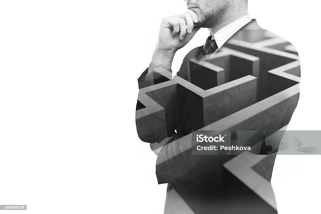 Business challenge Young businessperson thinking about ways to overcome business obstacle. Isolated on white background with maze and copy space. Double exposure Leadership Stock Photo