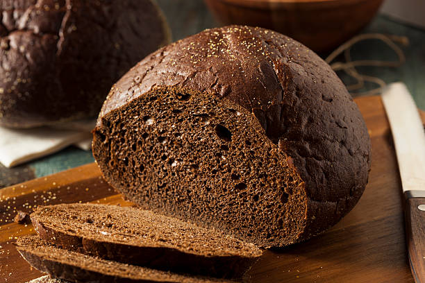 Homemade Organic Pumpernickel Rye Bread Homemade Organic Pumpernickel Rye Bread Cut into Slices rye stock pictures, royalty-free photos & images