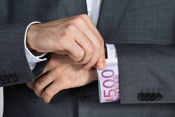 istock Businessman Putting Bribe In Suit Sleeve 600411176