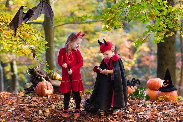 istock Kids on Halloween wearing devil and vampire costume 600411376
