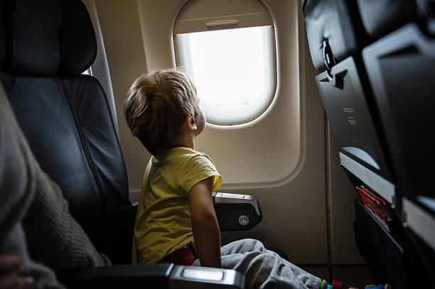 Little boy in airplane stock photo