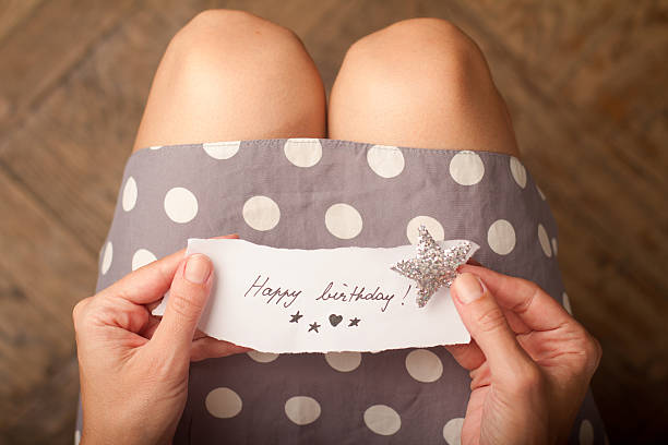 istock Woman holding a birthday note and a shiny star 600412030